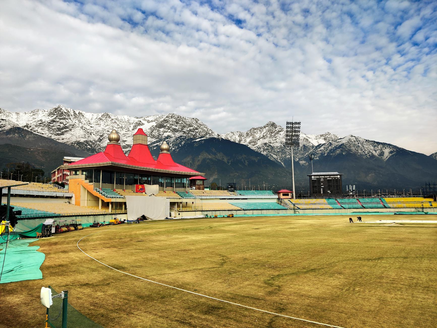 Scenic view of Dharamshala Cricket Stadium against stunning snow-capped mountains in Himachal Pradesh, India. - 11 Dead in Stampede Outside India Cricket Stadium