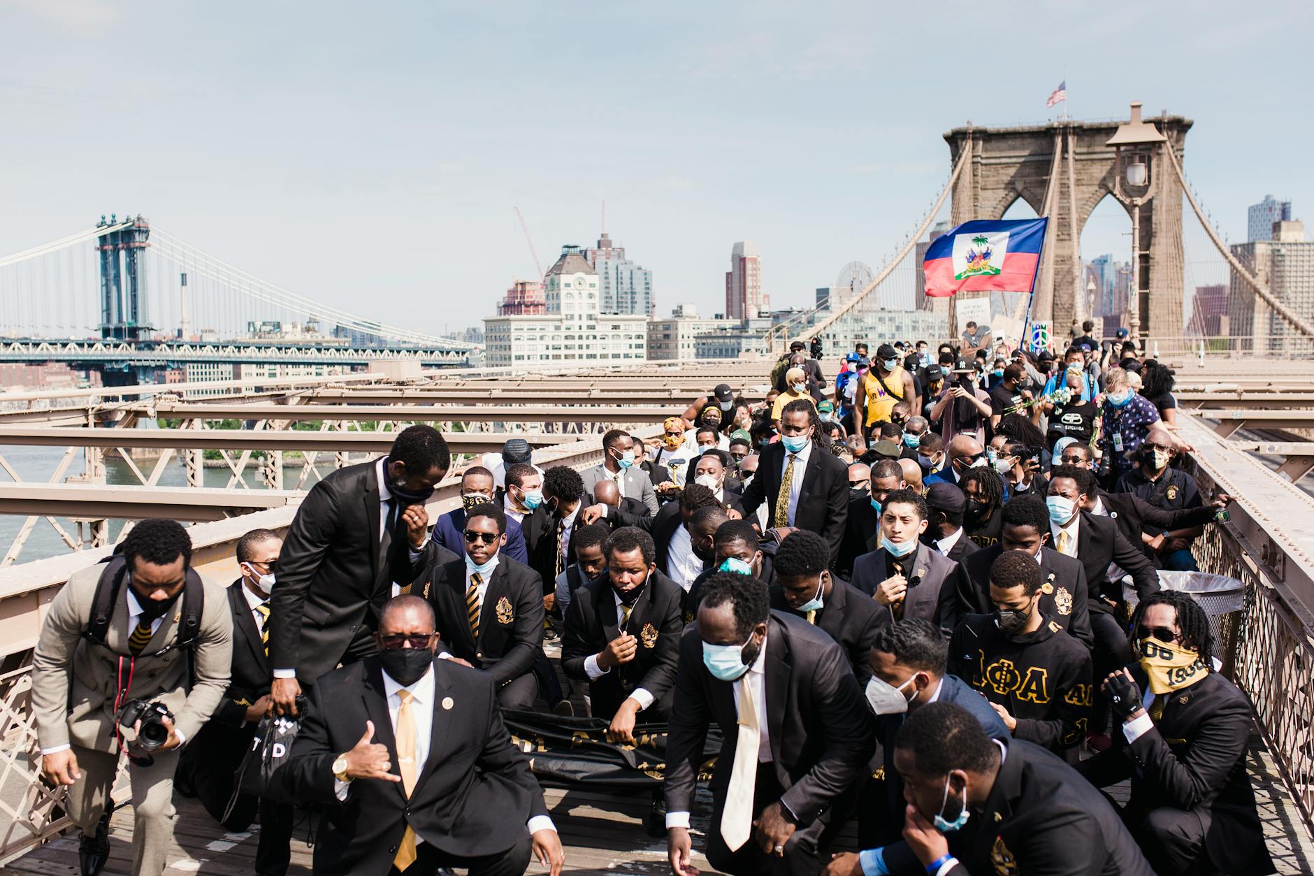 Andrew Cuomo Wins First NYC Democratic Mayoral Primary Debate 2 A large protest on Brooklyn Bridge featuring diverse participants advocating for justice and equality. - Andrew Cuomo Wins First NYC Democratic Mayoral Primary Debate