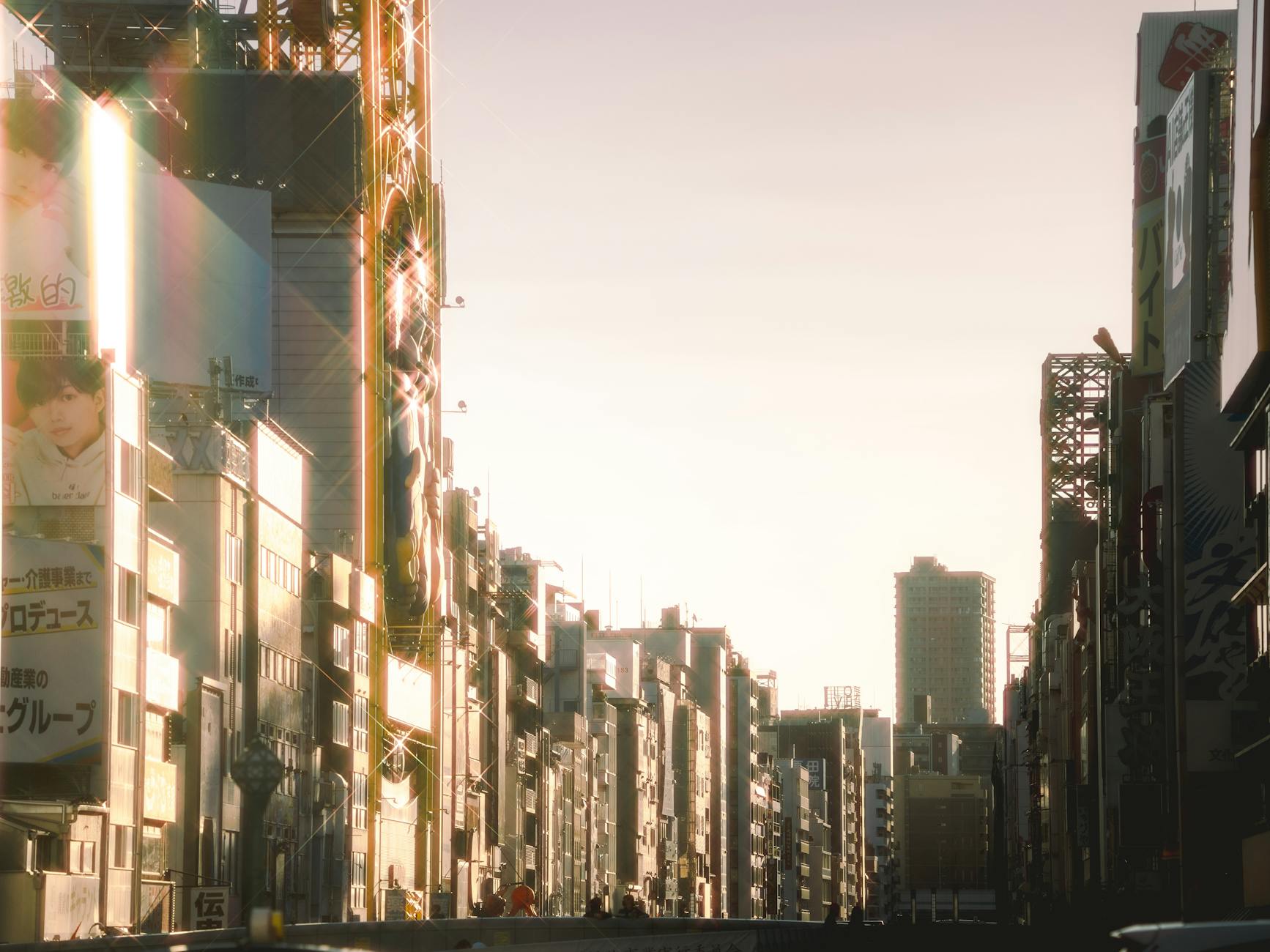 Sunset view of a bustling urban street with skyscrapers and billboards in Japan. - Japan's Nikkei Rises on Futures Demand, Weaker Yen