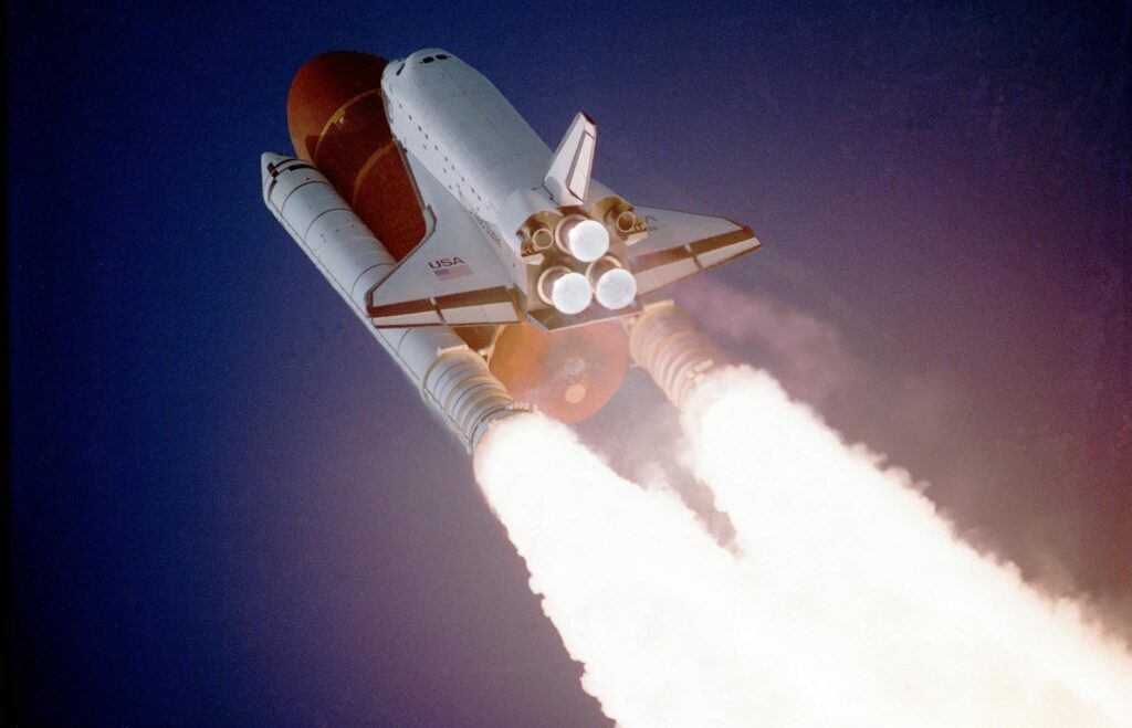 A space shuttle launches into space, showcasing powerful rocket engines and USA branding. - North Korea Raises Capsized Warship After Failed Launch