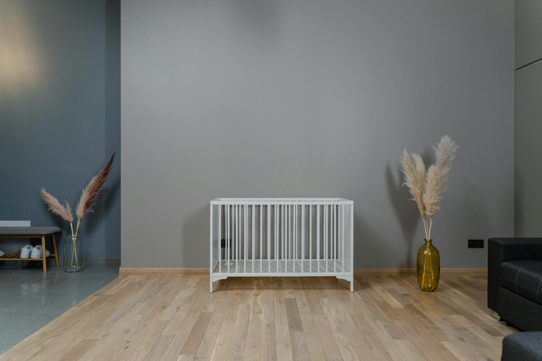 A modern minimalist nursery with a white crib and decor in earthy tones. - Tesla Shares Jump as Musk-White House Call Reported